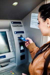 Young woman using a cash machine